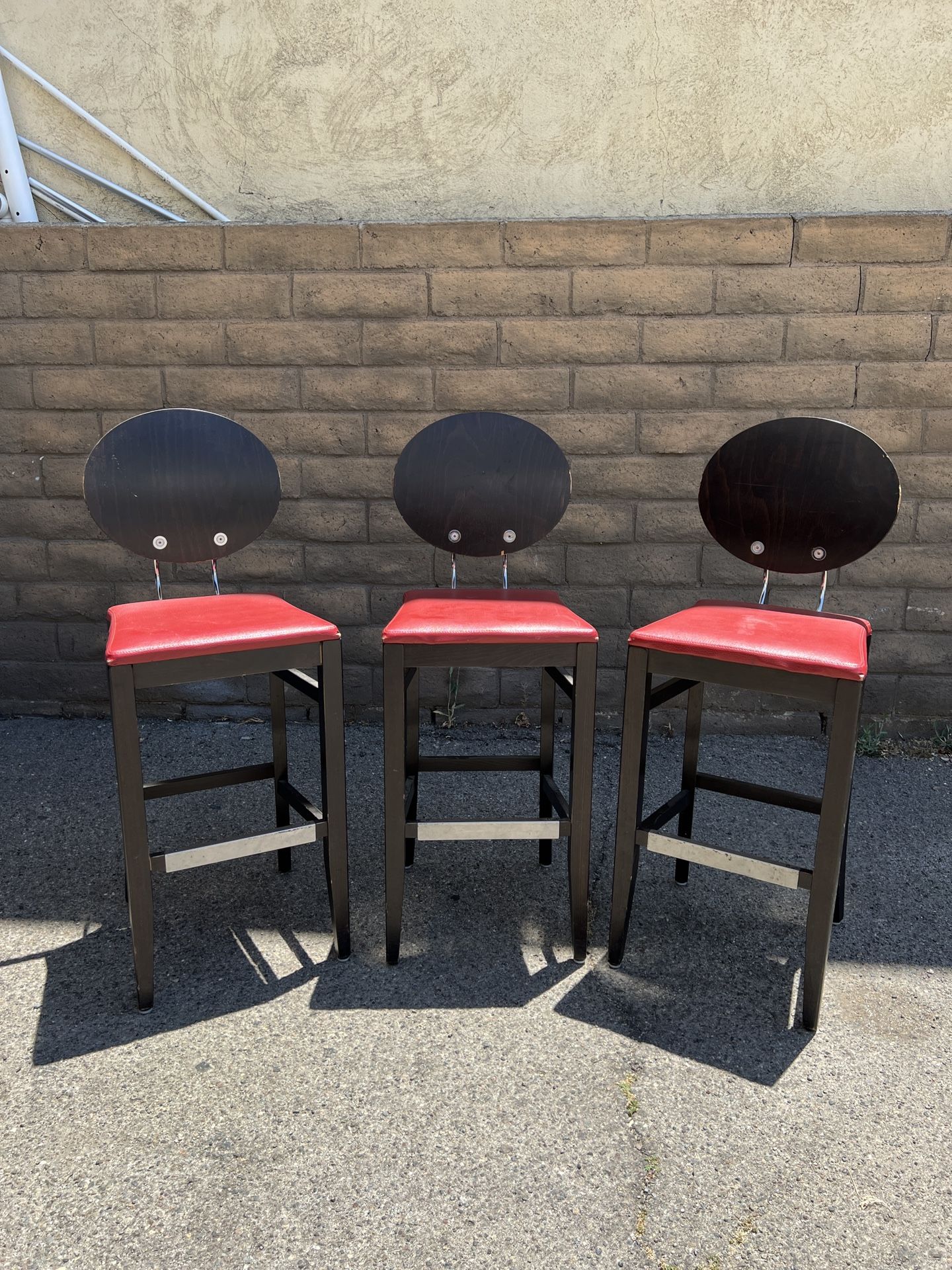 THREE RED AND BLACK BAR STOOLS