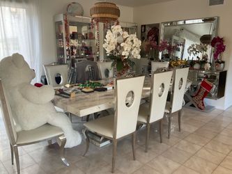 White marble table with chairs, cabinets, mirror