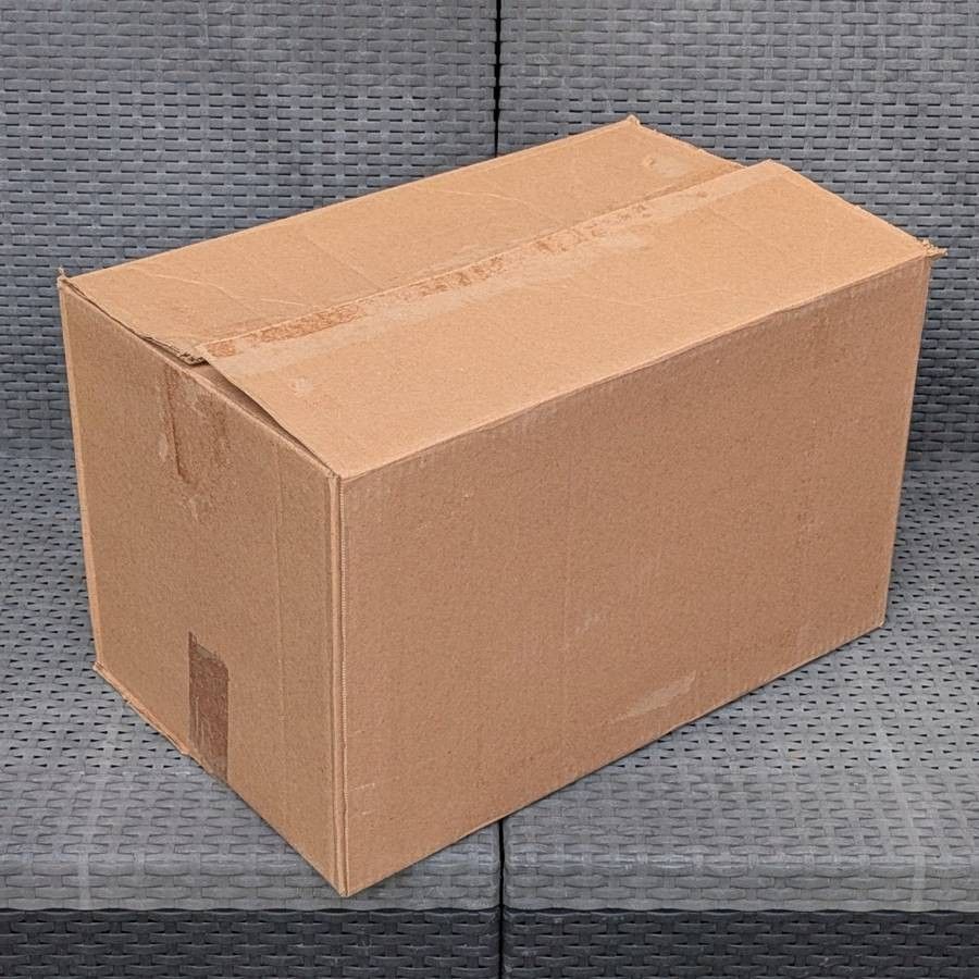 Clean medium size cardboard box and long strip of thick packing paper for shipping moving or storage
