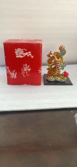 a highly detailed, multi-colored Taiwanese Koji Pottery (Cochin Ware) dragon statue grasping a red pearl (or Flaming Pearl of Wisdom) on a dark wooden