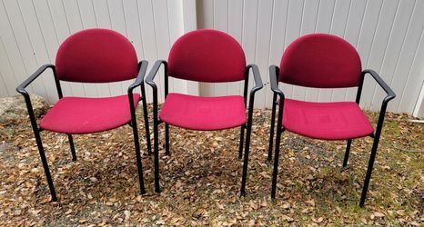 Set of three stacking arm chairs.