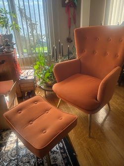 Orange mid-century modern chair and foot rest