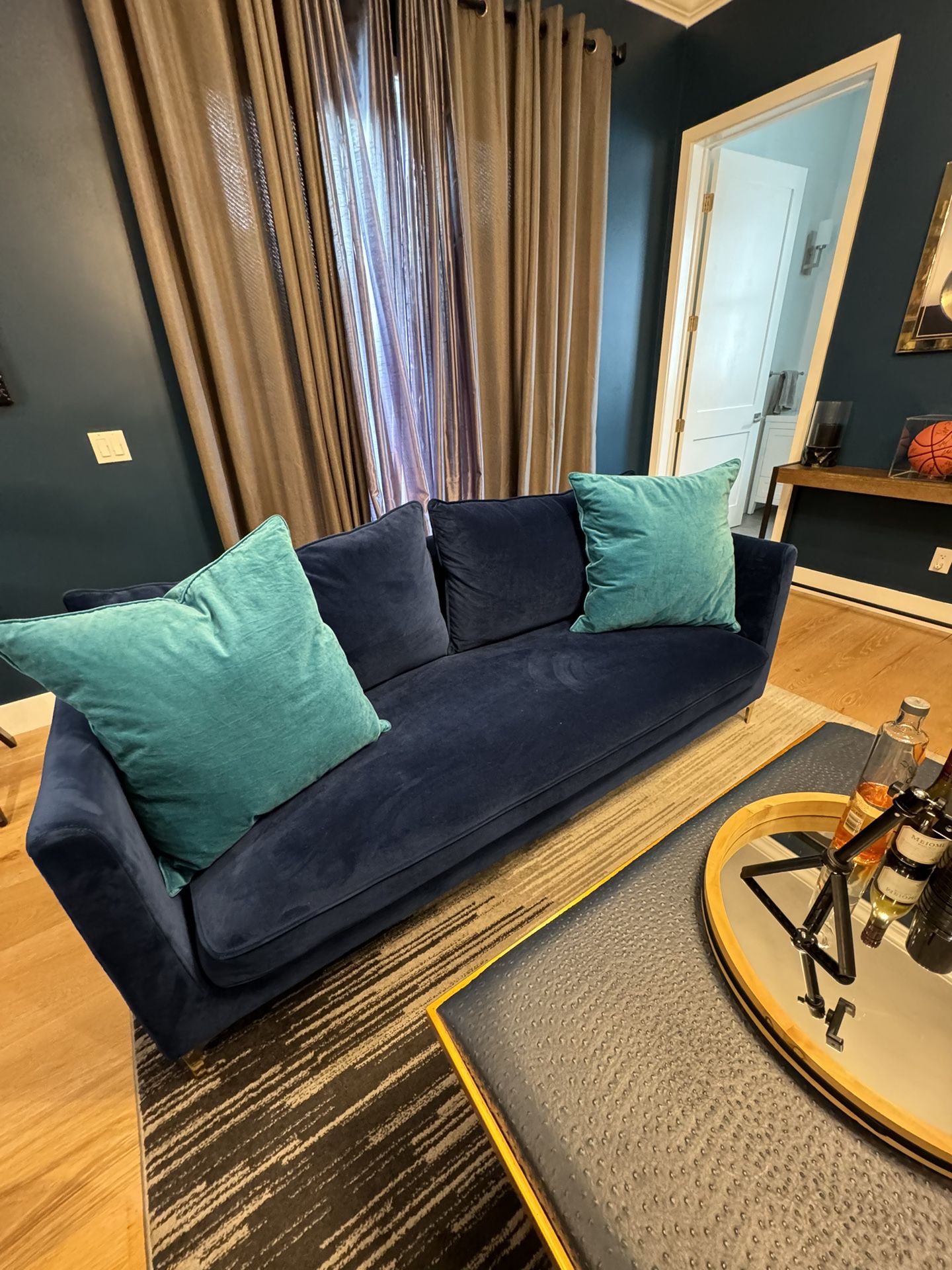 2 blue sofas with pillows 