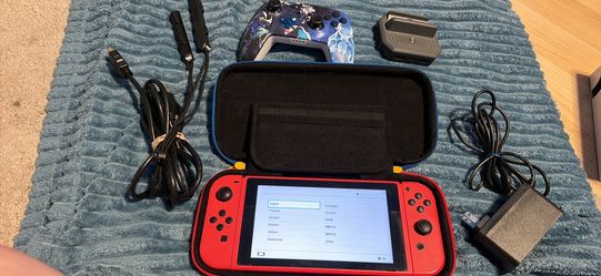 Nintendo switch with docking station, joycon grip, wrist straps, extra controller and hdmi.