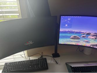 Dual Curved Samsung monitors w/ desk mount.