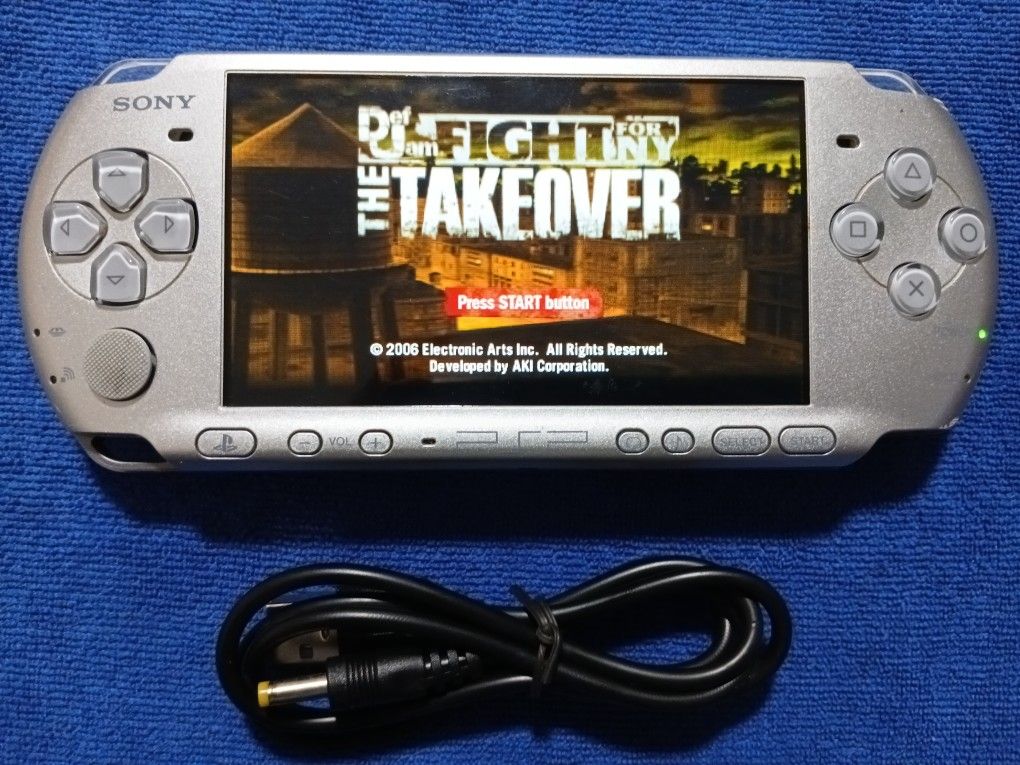 PSP 3000 With Charger And Games Inside. Works