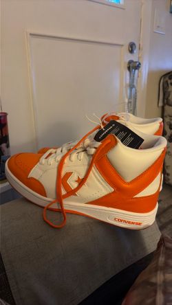 A pair of converse weapon high tops, orange , brand new