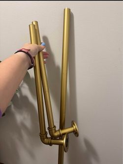 White curtains with a gold rod.