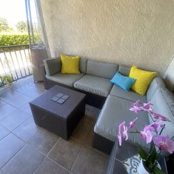 Patio sectional with coffee table and ottoman.