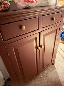 cabinet two drawers, two doors, maroon color