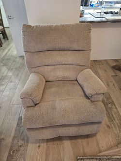 Upholstered fabric rocker recliner.