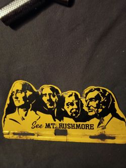 vintage "See Mt. Rushmore" metal license plate topper.