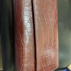 Brown croc pattern wallet snap closure many compartments for cards and other items. 2 zippers 