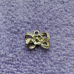 Pendant: golden bow with accent stones