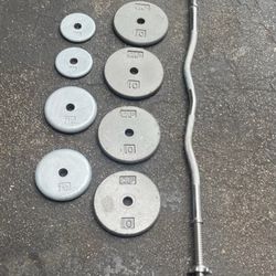 STANDARD SIZE CURL BAR & 60 LBS. OF PLATES (FOUR) 10s  +TWO)  7.5s  &  2.5s (INCLUDING BAR = 70 LBS. TOTAL)