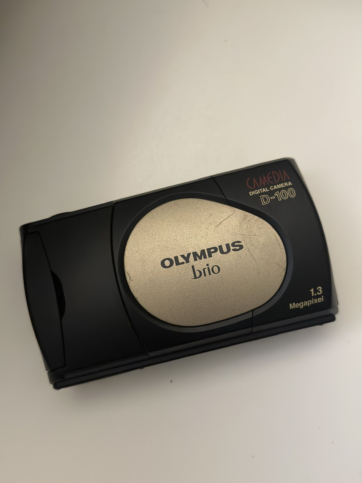 Olympus Brio black and gold digital camera with 13 megapixel sensor