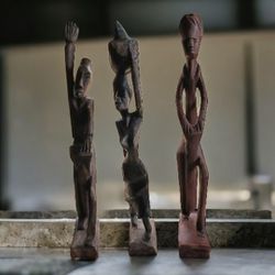  hand carved statues, small chip in wood at the base of the first one.