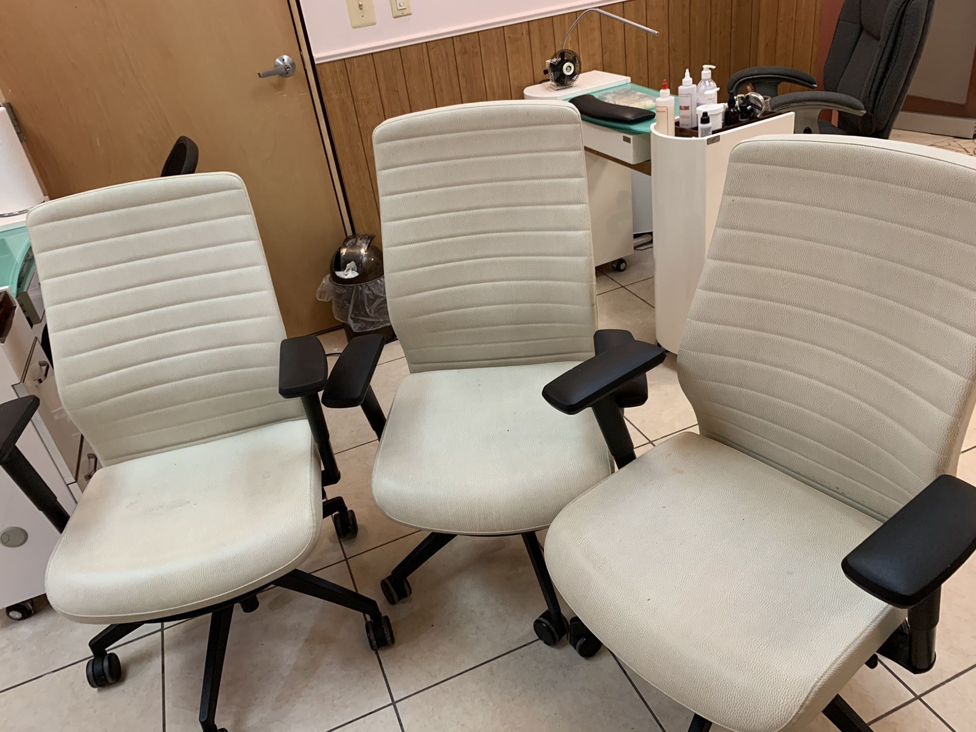 3 white office chairs