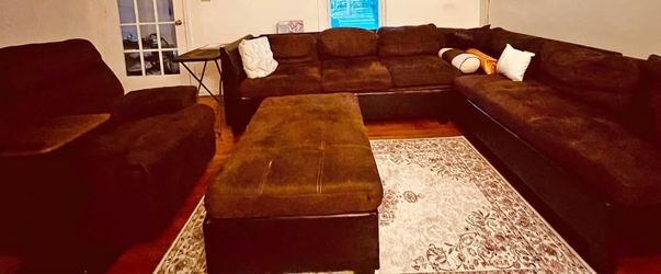 Large brown microfiber sectional sofa with ottoman and armchair