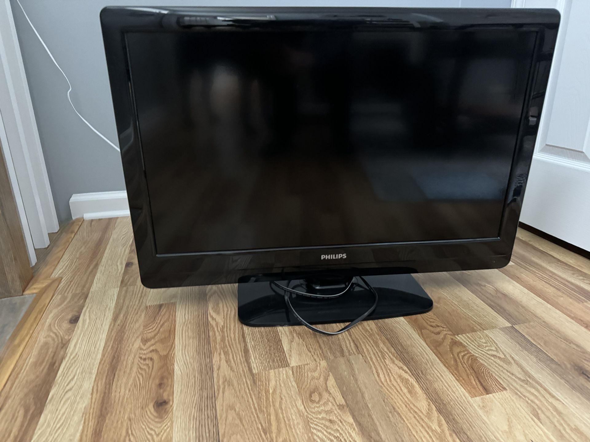 Philips 32” TV with apple TV remotes and wires