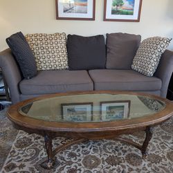 Dark wood and glass oval coffee or sofa table. Traditional