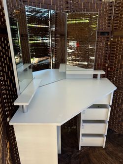 White Corner Makeup Vanity with Tri-Fold Mirror used in very good condition.