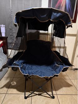portable folding camping chair with a built-in privacy canopy, designed to provide shade and added seclusion while relaxing outdoors.