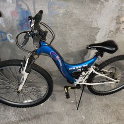 blue MGX Uptown dual-suspension bicycle.
