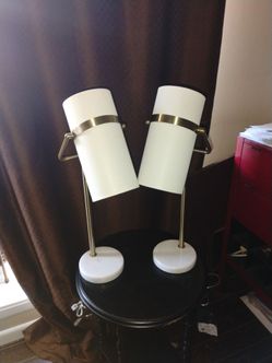 A pair of white and gold lamps
