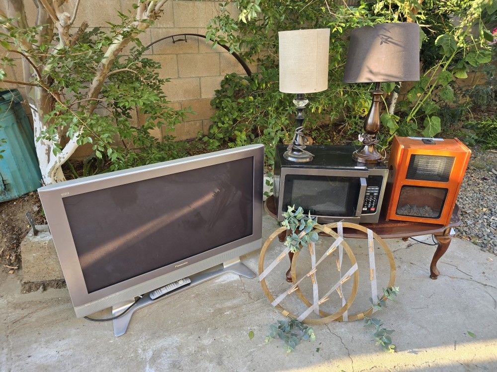 Tv. Microwave. Heater. 2 Lamps. And 2 Picture Frames. Coffee Table