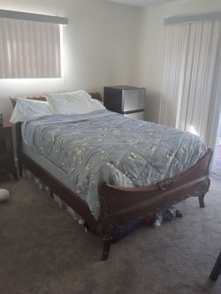 Full sized wooden bed frame with box spring and mattress