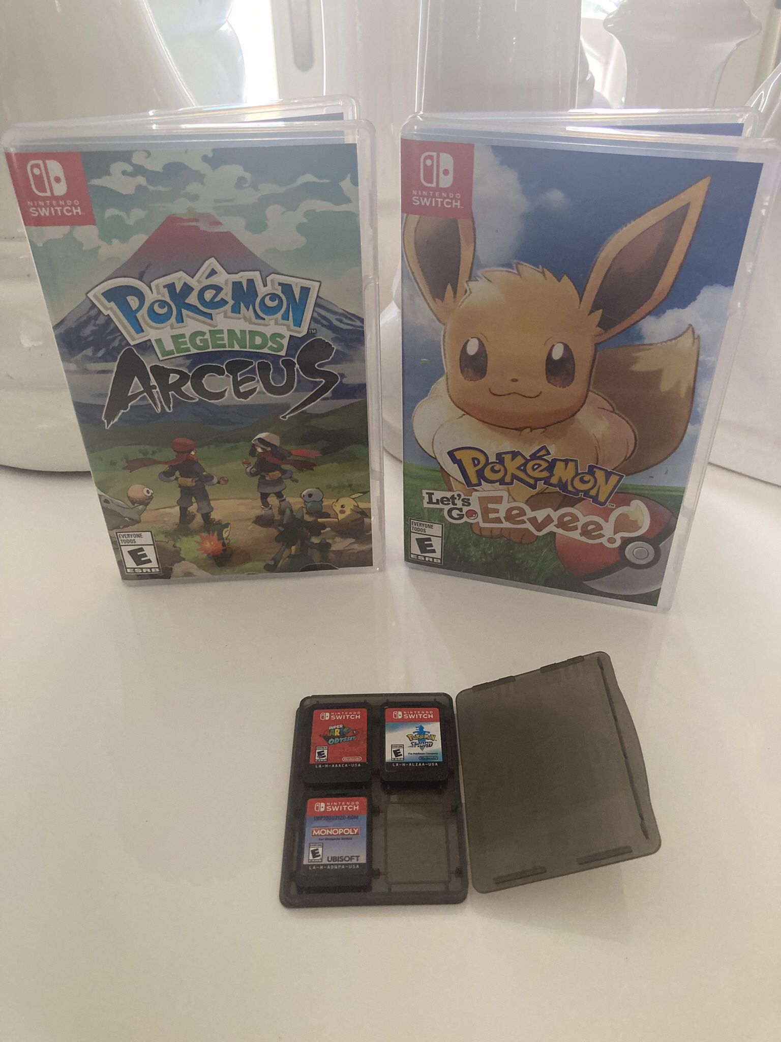 5 Nintendo Switch Games - Pokémon Let’s Go Eevee - Pokémon Legends Arceus - Pokémon Sword - Super Mario Odyssey - Monopoly