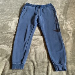 Blue Nike sweatpants with adjustable waistband
