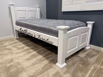 White twin bed and mattress