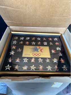 This framed item is a 1982/1983 Olympic Pin Set (Series 2) from the 1984 Summer Olympics held in Los Angeles, https://offerup.com/redirect/?o=Q2FsaWZv