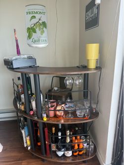 3 tier bar table with glassware slots. Dark wood and black