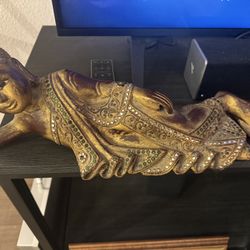 Decorative reclining Buddha figure, likely late 20th century.