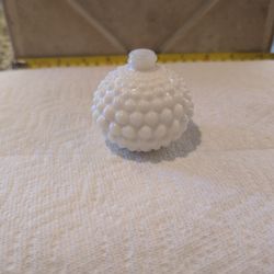 vintage white milk glass perfume or cologne bottle featuring a prominent hobnail textured pattern.