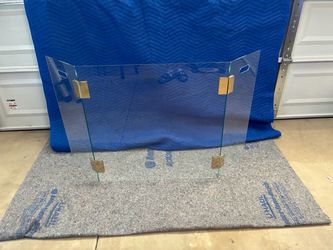three-panel clear glass fireplace screen