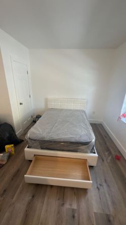 New full-size bed with a drawer, in the box.