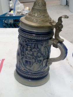 This is a vintage German stoneware beer stein featuring a blue salt glaze and a pewter lid.