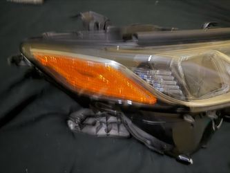 “2018 Toyota Camry SE passenger-side front headlight.”