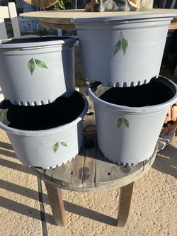 Garden plastic pots (3) 12 inches high and (1) is 11.5 inches high and about 10 inches wide on all (4)