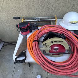 Air Hoses And Electric Hand Saw