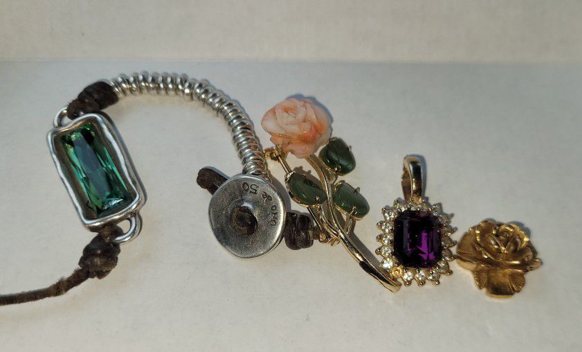 Lot of 4 jewelry pieces.  The bundle includes 

1. Rolled in 18k single Rose yellow. 

2.  Silver .925 Bracelet With Emerald Baguette Style Cut Stone.