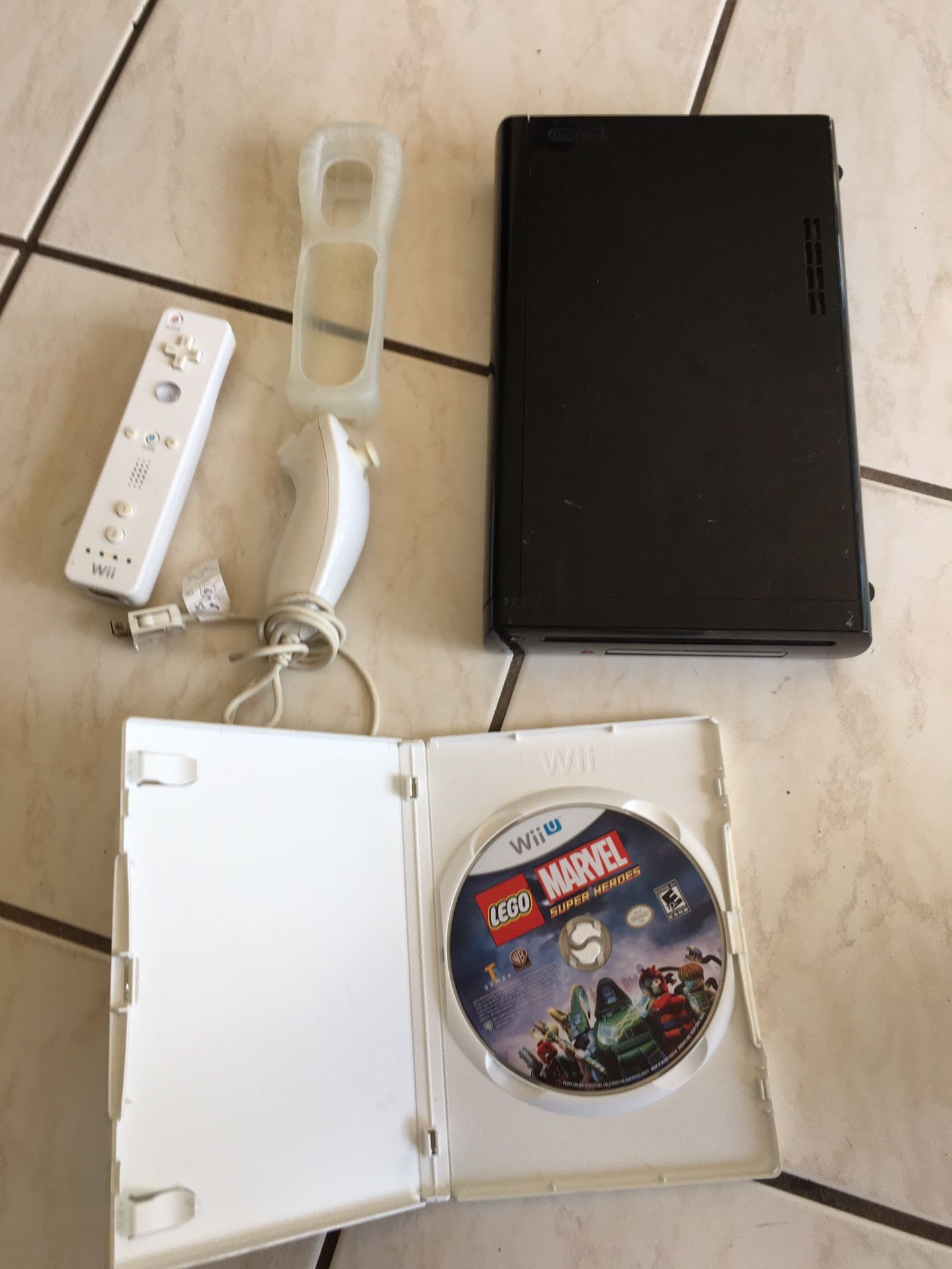 Nintendo Wii U Console Only (No cords), 1 remote, 1 silicone remote cover, 1 nunchuck remote, 1 Game