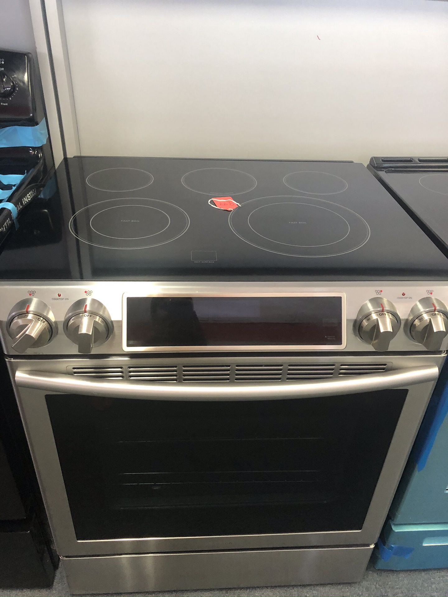 Used Samsung 4 burner glass top stainless steel slide in range. 1 year warranty