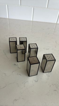 Three sets of mid-century modern mirrored salt and pepper shakers.