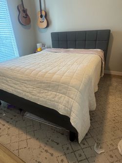 Queen sized grey upholstered bed frame