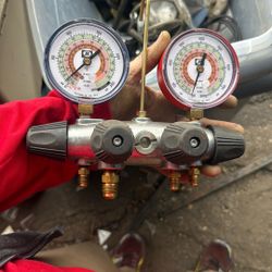 Refrigerant Manifold with gauges and hoses, a professional-grade HVAC service tool. 